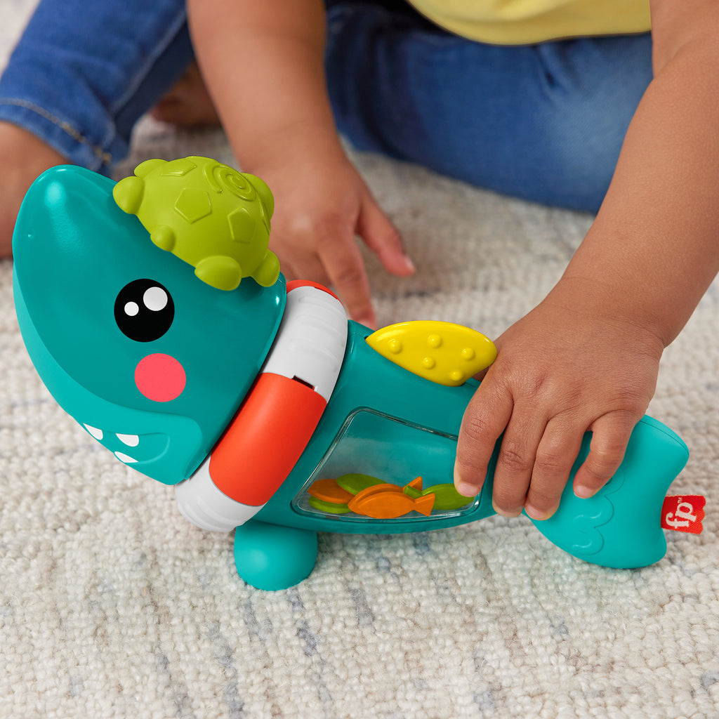 Bebeklerin ince motor becerilerini geliştiren ve duyusal gelişime yardımcı özellikleri bulunan Fisher Price Eğlenceli Köpek Balığı