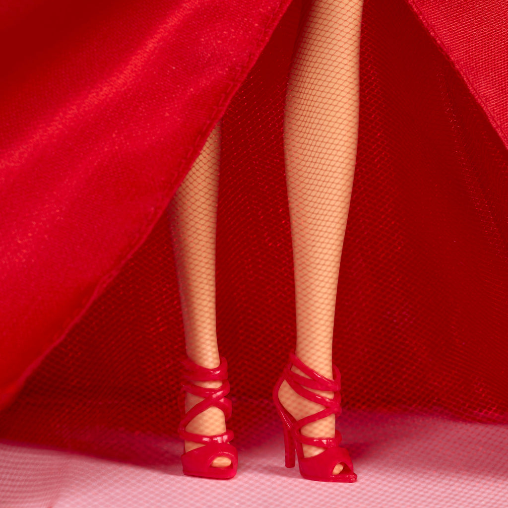 Barbie Signature 2026 Mutlu Yıllar Barbie bebeği, sezona özel koleksiyon ürünü, fiyonk detaylı kırmızı elbise giyen koyu kahverengi saçlı bebek